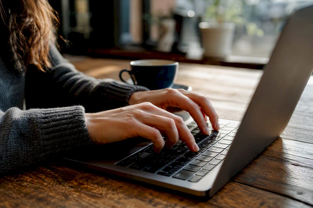 Hands triggering screenshot on laptop keyboard